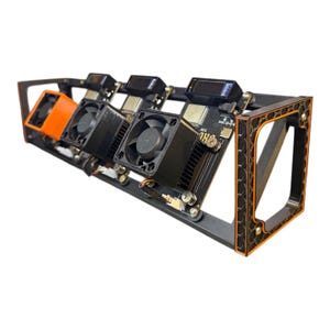 May include: A black and orange computer component rack with multiple circuit boards, fans, and small digital displays. The rack has a rectangular frame with an orange trim and is designed to hold and cool electronic components.