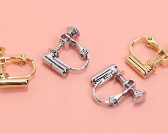 May include: Four pairs of clip-on earrings in gold and silver tones. The earrings have a screw-on design and a curved shape.