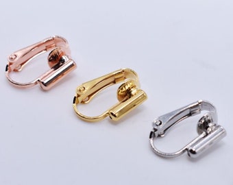 May include: Three earring clips in gold, rose gold, and silver. The clips are designed to hold earrings in place.
