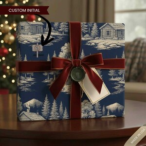 May include: A wrapped gift with dark blue landscape-patterned paper, tied with a burgundy velvet ribbon and bow. A small sign with the letter "S" is attached. A gold-edged tag and a green wax seal complete the presentation.