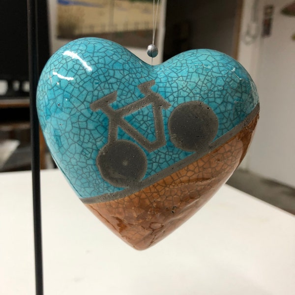 Raku fired ceramic heart, turquoise and amber bicycle image