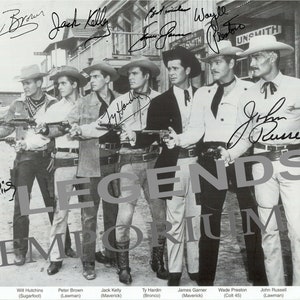 May include: A black and white photograph of seven actors from 1950s and 1960s Western television series. The actors are standing in a row, holding guns, and looking at the camera. The actors are identified as Will Hutchins, Peter Brown, Jack Kelly, Ty Hardin, James Garner, Wade Preston, and John Russell. The photo is signed by all seven actors.