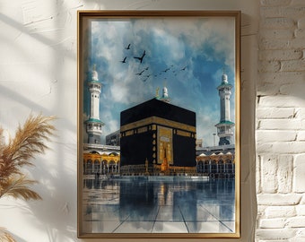 May include: A watercolor painting of the Kaaba in Mecca, Saudi Arabia. The painting is framed in a gold frame and hangs on a white wall. The painting is surrounded by a few decorative items, including a vase with dried pampas grass.