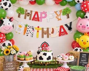 May include: A farm-themed birthday party setup featuring a balloon arch, a banner spelling HAPPY BIRTHDAY, a cow-print cake, cupcakes, and a chalkboard sign with the text OINK MOO CLUCK HAPPY BIRTHDAY and FARM FRESH BIRTHDAY FUN.