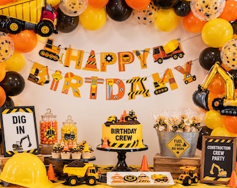 May include: A construction-themed party display featuring a Happy Birthday banner, a yellow cake labeled Birthday Crew, a yellow hard hat, toy dump trucks, cookies, and a metal bucket labeled Fuel for Big Work, all decorated with black and yellow balloons.