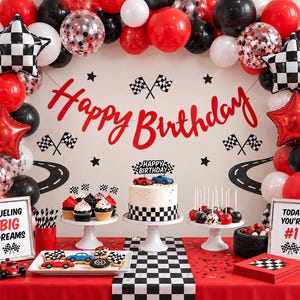 May include: A race car themed birthday party setup featuring a red, black, and white balloon arch, a cake with a checkered base, cupcakes with checkered flag toppers, and signs reading Happy Birthday, Fueling Big Dreams, and Today You're #1.