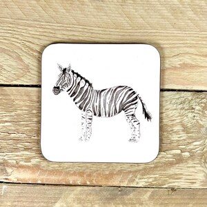 May include: A black and white zebra illustration on a white coaster. The zebra is facing left and has a striped pattern.