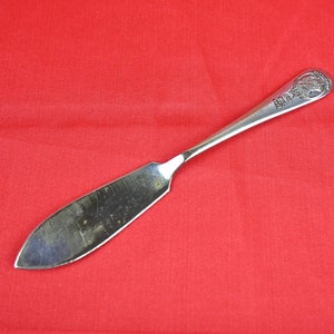 May include: A silver butter knife with a decorative handle featuring a design of a woman's head and the text "1847 Rogers Bros."