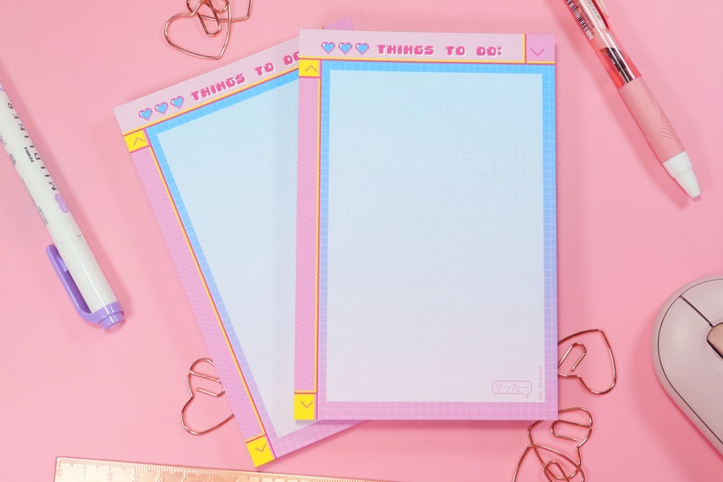 May include: Two pink and blue gridded notepad sets with the text "THINGS TO DO:" in a pixelated font. The notepads have a pink and blue gradient border with hearts and arrows.