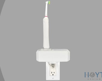 Puede incluir: Soporte de pared blanco para cepillo de dientes eléctrico. El soporte tiene un estante para el cepillo de dientes y un espacio para la base de carga.