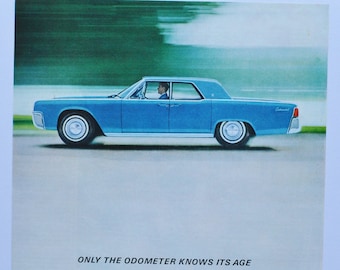 May include: Vintage advertisement featuring a blue Lincoln Continental car in motion. The car has a sleek design with white-walled tires. The ad includes the text "ONLY THE ODOMETER KNOWS ITS AGE" and additional text about the car's features.