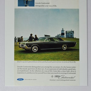 May include: A black Lincoln Continental car is parked on a grassy hill overlooking a lighthouse and a small town. The car is a luxury motorcar that stands apart from all other cars. The text on the ad reads: "Lincoln Continental distinguishes your way of life."  "Lincoln Continental. America's most distinguished motorcar."