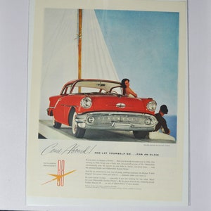 Grande pubblicità per auto 1957 Oldsmobile Golden Rocket 88 Holiday Coupe (vecchia pubblicità fotografica classica della GM, parti stampate Oldsmobile Eighty-Eight)