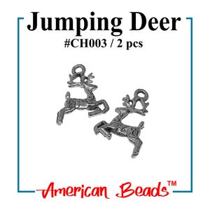 May include: Two silver-colored Jumping Deer charms. Each charm features a detailed design of a deer in mid-jump, with antlers and decorative patterns. The text "Jumping Deer" and "#CH003 / 2 pcs" is displayed above the charms. The brand name "American Beads" is also visible.