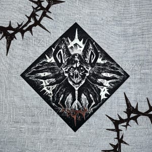 May include: Black and white illustration of a bat-like skull within a diamond shape, with spiky thorns around the edges. The design has a gothic or dark aesthetic, with intricate details and a textured background.