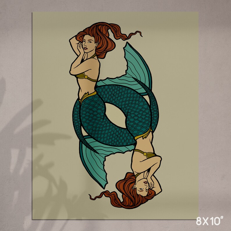 May include: An 8x10 inch print featuring two mermaids in a mirrored design. The mermaids have red hair, teal fishtails, and are wearing gold-colored tops. The background is a light beige color.