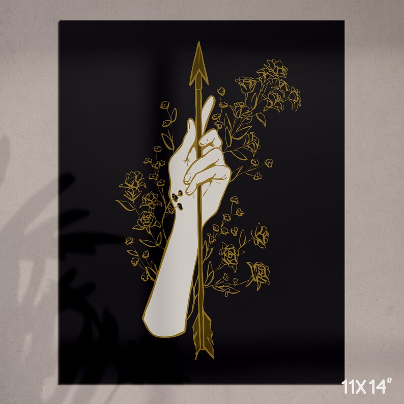 May include: A hand holding an arrow with a gold outline, surrounded by gold flowers on a black background.
