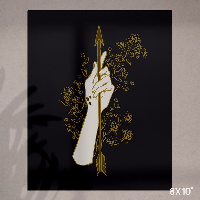 May include: A gold outline illustration of a hand holding an arrow, with floral details on a black background.