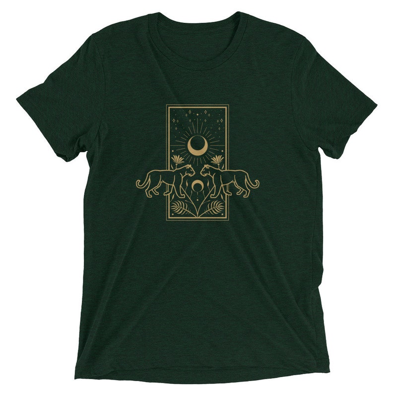 Może przedstawiać: Zielony t-shirt z nadrukiem w kolorze złotym przedstawiającym dwie pantery zwr&oacute;cone do siebie, nad kt&oacute;rymi znajduje się sierp księżyca i gwiazdy.