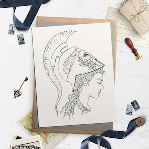 May include: A black and white line drawing of a woman wearing a helmet with a laurel wreath. The woman is looking to the right and has long, curly hair.