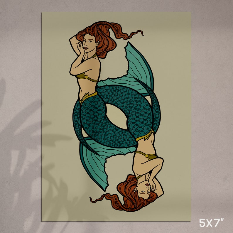 May include: A 5x7 inch print featuring two mermaids in a mirrored design. The mermaids have red hair, teal fishtails, and are wearing olive green tops. The background is a light beige color.