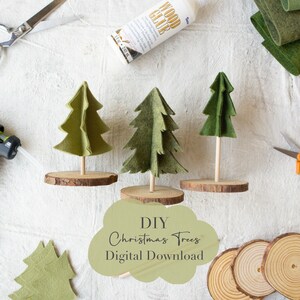 May include: DIY Christmas Trees Digital Download. Three felt Christmas trees on wooden bases, with a bottle of wood glue, felt scraps, and a hot glue gun in the background.