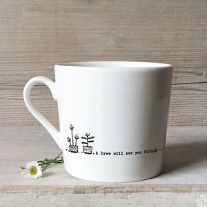 May include: White ceramic mug with a black illustration of three potted plants and the text "... A brew will see you through..."