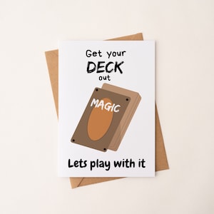 May include: A white card with black text that says "Get your DECK out" and a brown deck of cards with the word "MAGIC" on it. The text below the cards says "Lets play with it".