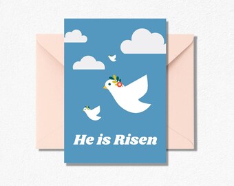 May include: Greeting card with a blue background featuring white doves, clouds, and the text "He is Risen." The doves are adorned with floral and olive branch details. A pink envelope is included.