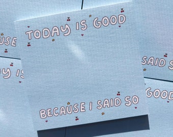 May include: A stack of blue note cards with the text "Today is good because I said so" printed on them. The cards are decorated with small red cherries and yellow stars.