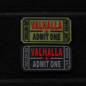 May include: Two black and green fabric patches with the text "Valhalla Die Historic Live Again Admit One" in red and white. The patches are in the shape of a ticket.