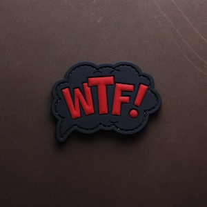 May include: Black and red embroidered patch with the text "WTF!" in a speech bubble shape.