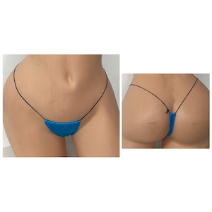 May include: A turquoise thong bikini with thin black straps. The bikini bottom has a small, curved design. The image shows the front and back views of the bikini on a mannequin.