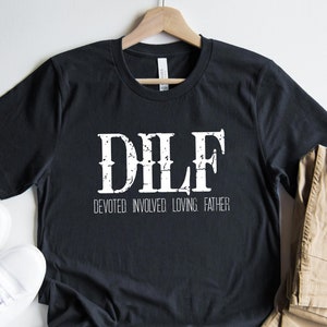 May include: Black t-shirt with white text that reads "DILF" and "Devoted Involved Loving Father".