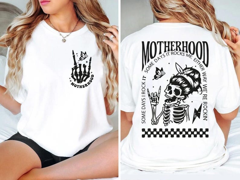 May include: White t-shirt with a black skeleton hand design and the text "Motherhood" on the front. The back of the shirt has a black skeleton design with the text "Motherhood Some days I rock it Some days it rocks me. Either way we're rockin'"