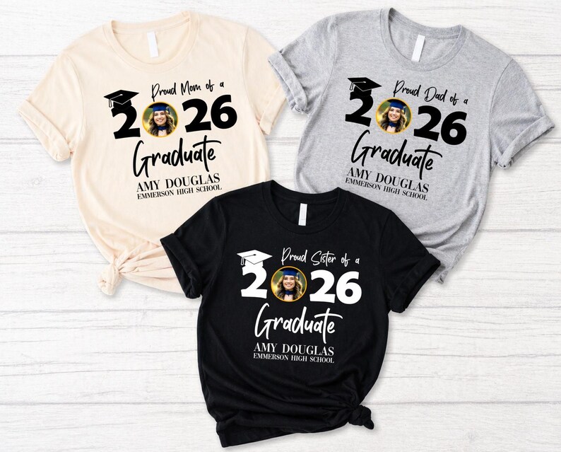 May include: Three t-shirts with graduation-themed designs. One is cream-colored, one is gray, and one is black. Each shirt features the text "Proud Mom of a 2026 Graduate", "Proud Dad of a 2026 Graduate", and "Proud Sister of a 2026 Graduate".