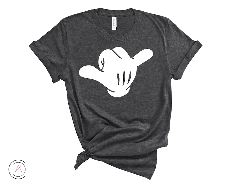 May include: A dark grey t-shirt featuring a white cartoon hand making the shaka sign.