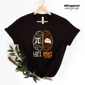 May include: Black t-shirt with a graphic of a brain divided into two halves. The left side shows the mathematical symbol for pi and the text "LEFT I LOVE PI". The right side shows a slice of pie and the text "RIGHT DID SOMEONE SAY PIE?"