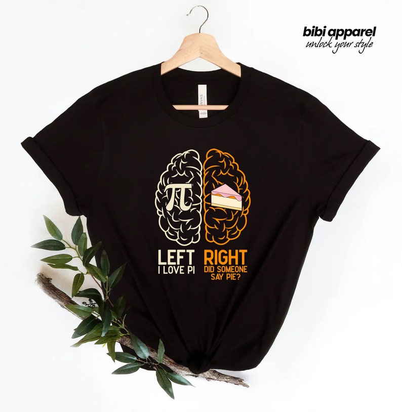 May include: Black t-shirt with a graphic of a brain divided into two halves. The left side shows the mathematical symbol for pi and the text "LEFT I LOVE PI". The right side shows a slice of pie and the text "RIGHT DID SOMEONE SAY PIE?"