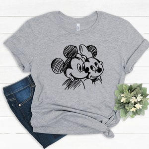 May include: A gray t-shirt with a black and white sketch of Mickey Mouse and Minnie Mouse on the front.