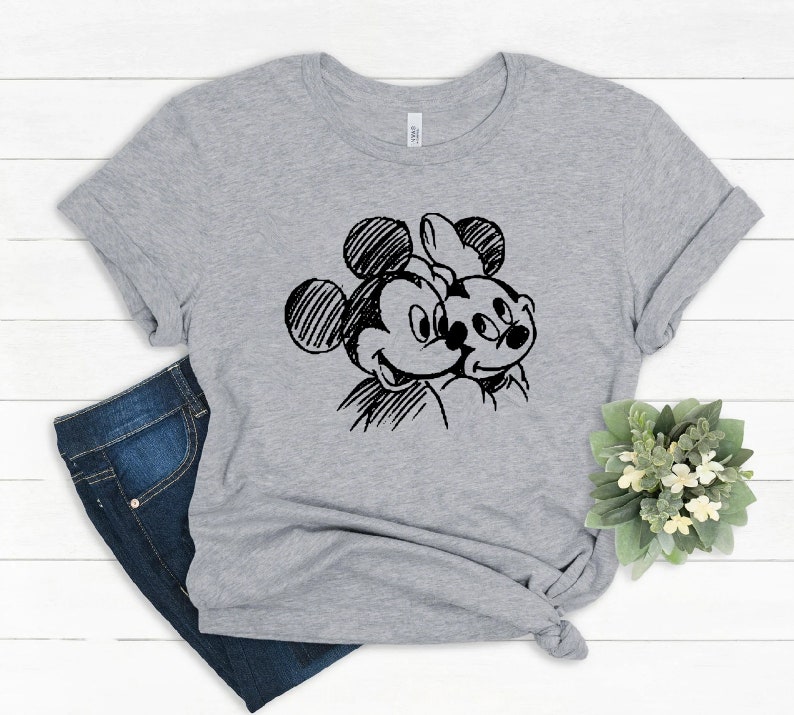 May include: A gray t-shirt with a black and white sketch of Mickey Mouse and Minnie Mouse on the front.