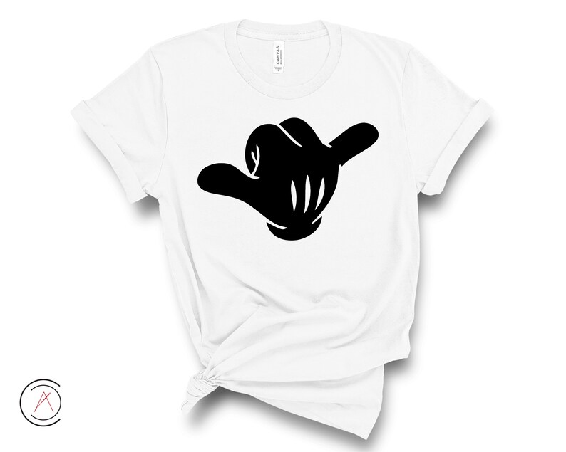 May include: White t-shirt featuring a black silhouette of a hand making the shaka sign.