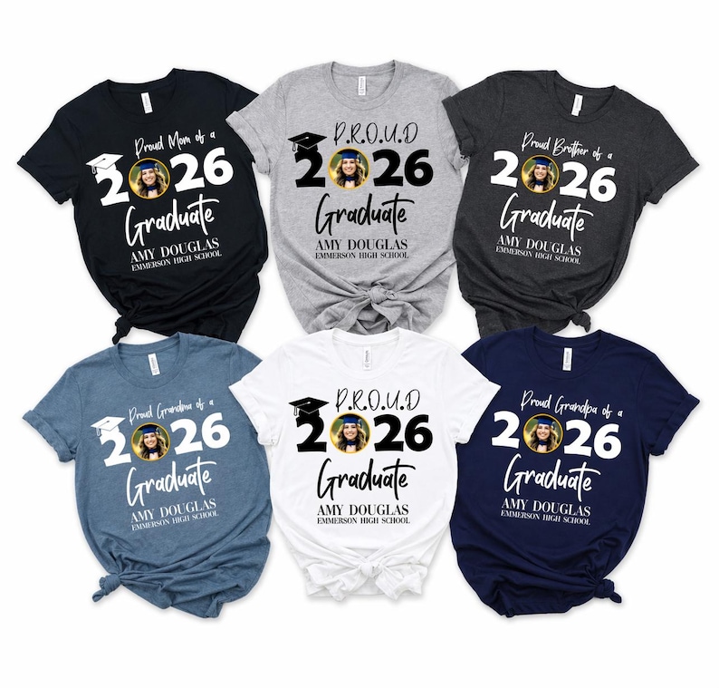May include: A collection of graduation-themed t-shirts in various colors, including black, gray, and blue. Each shirt features the text "Proud Mom/Brother/Grandpa of a 2026 Graduate" with a photo and the graduate's name and school.