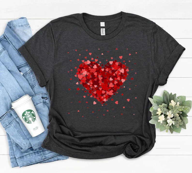 May include: A dark gray t-shirt with a red heart made of smaller red hearts. The heart is surrounded by smaller red hearts.