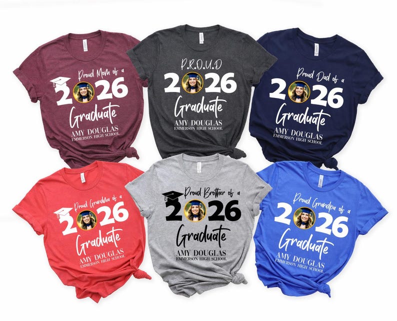 May include: A collection of six short-sleeved t-shirts in various colors, each featuring a graduation-themed design. The shirts display the text "Proud Mom of a 2026 Graduate," "Proud Dad of a 2026 Graduate," and other family-related phrases.