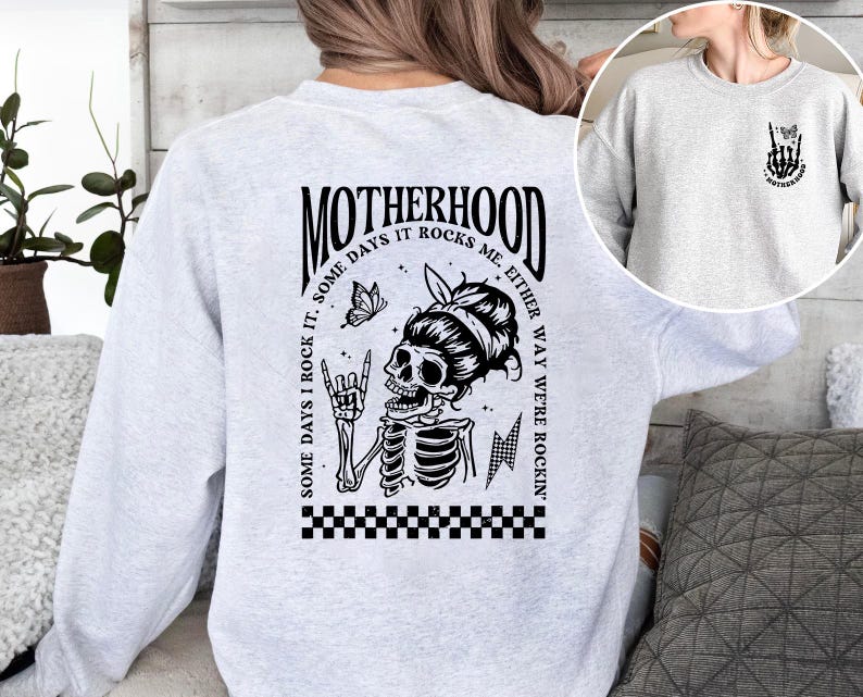 May include: Gray sweatshirt with a black and white graphic of a skeleton with a butterfly and the text "Motherhood. Some days I rock it. Some days it rocks me. Either way we're rockin'."