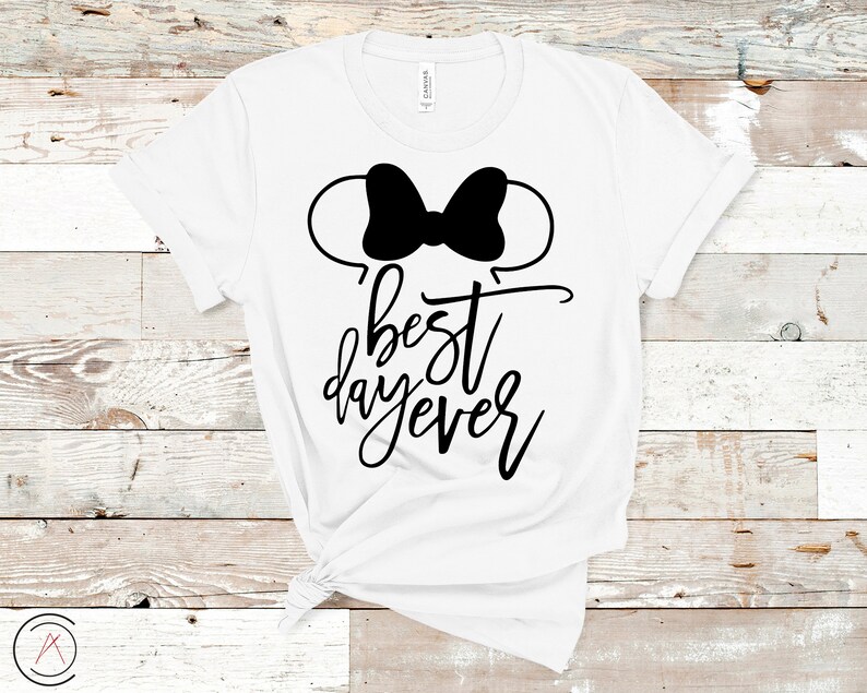 May include: White t-shirt with a black Mickey Mouse ears silhouette and the text "best day ever" in black script.