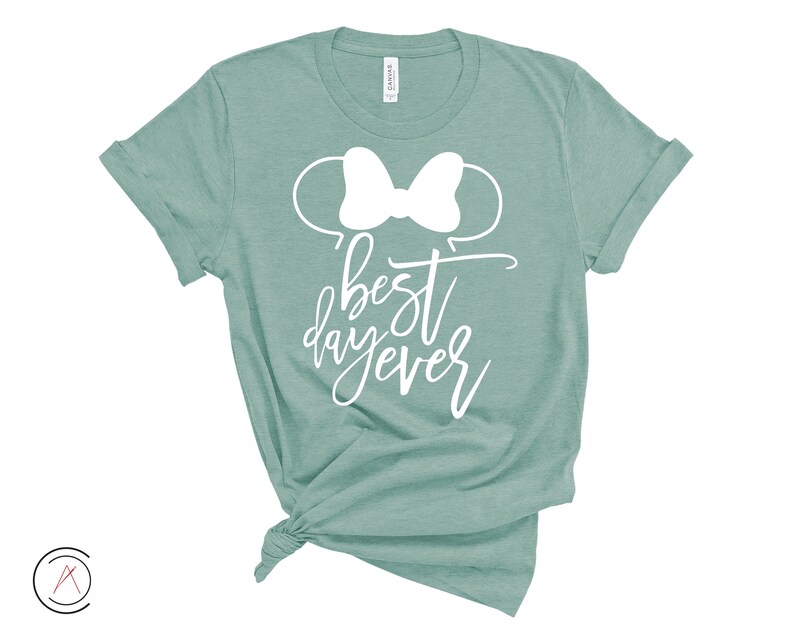 May include: A teal green t-shirt with a white bow and the text "best day ever" printed on the front.