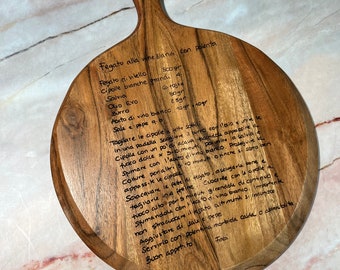 May include: A wooden cutting board with a handwritten recipe for Venetian liver with polenta. The recipe includes ingredients like veal liver, onions, sage, olive oil, butter, white wine vinegar, salt, and pepper.