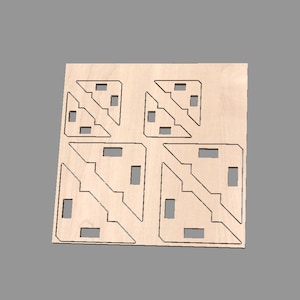 May include: Four wooden corner brackets with intricate cut-out designs. The brackets are arranged in a square pattern on a light brown surface.